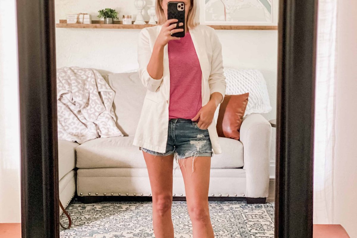 Woman with white blazer, pink tank, and shorts. mirror selfie